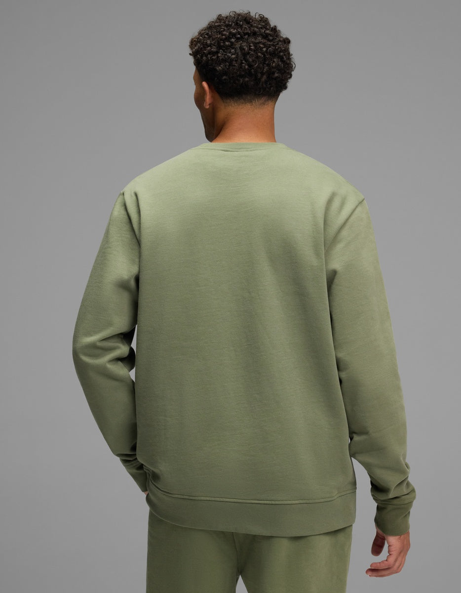 Back view of a person wearing an olive green Men’s Dylan Crewneck.