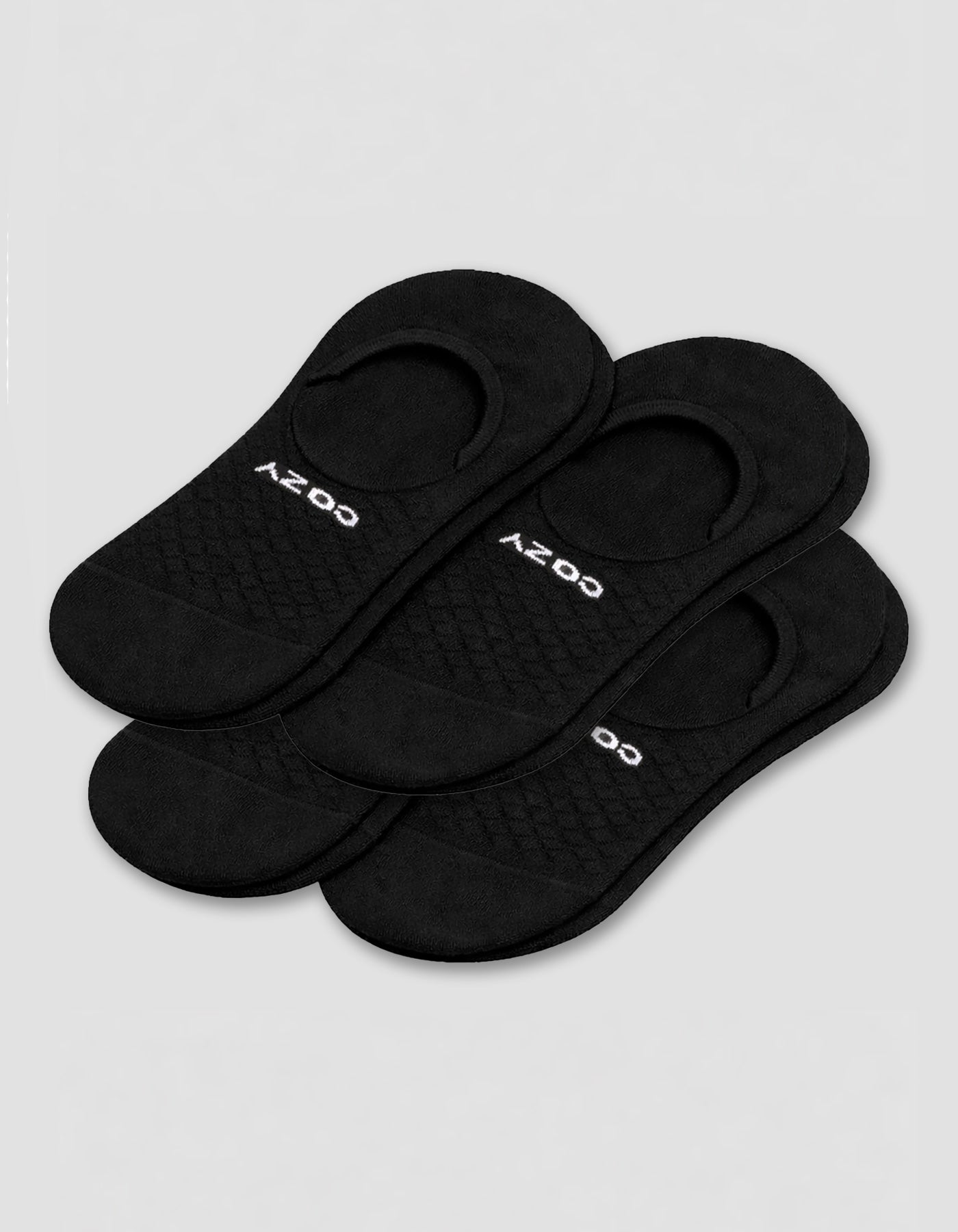 A 4-pack of black Men's Essential No-Show Socks by Cozy Earth, each pair featuring "COZY" in white, displayed on a plain white background.