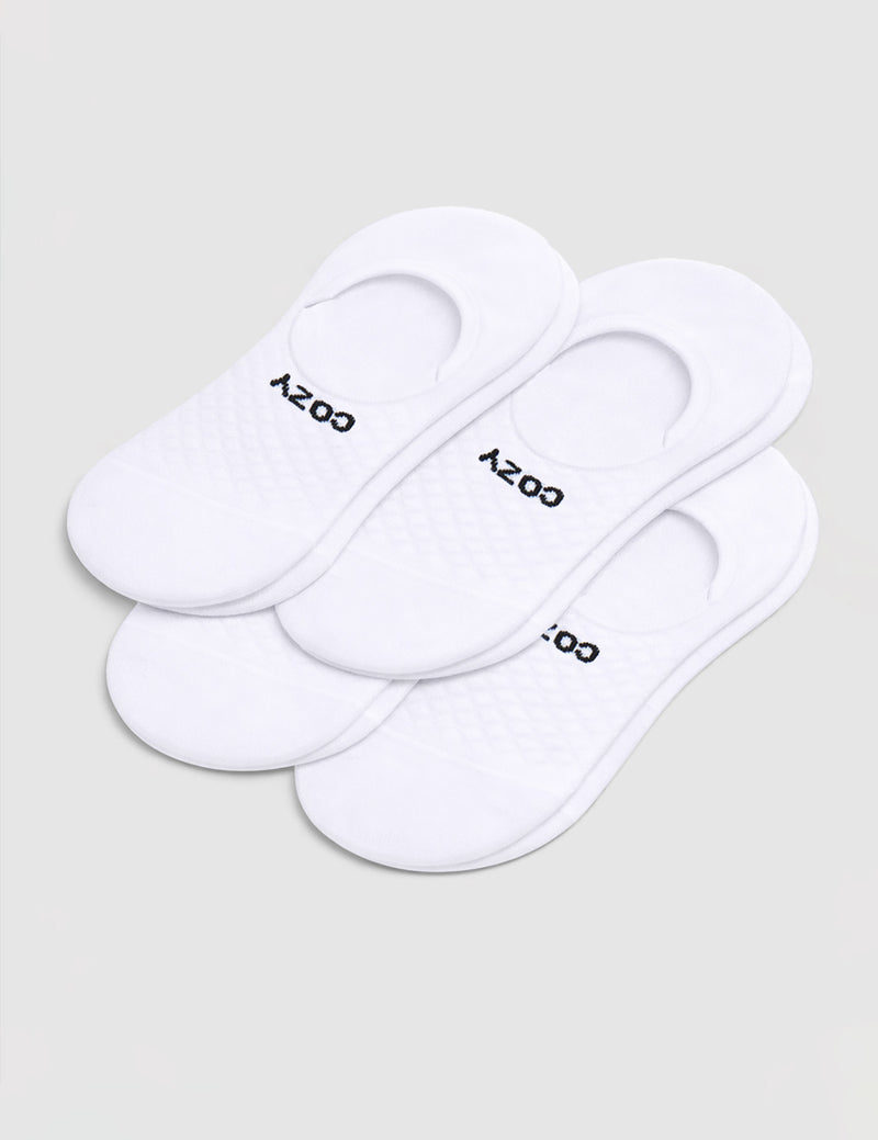 A 4-pack of white Men's Essential No-Show Socks by Cozy Earth, each pair featuring "COZY" in black, displayed on a plain white background.