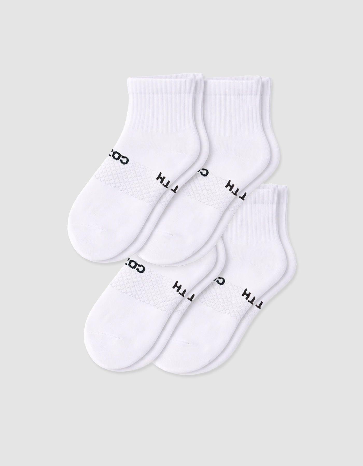 Four pairs of Cozy Earth Women's Essential Quarter Socks in white, featuring ribbed cuffs and black text, are arranged overlapping on a plain light background.
|Color:White
