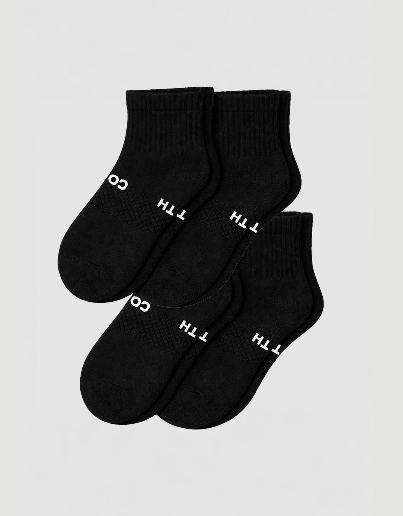 Four pairs of Cozy Earth Women's Essential Quarter Socks in black, featuring ribbed cuffs and white text, are arranged overlapping on a plain light background.
|Color:Black