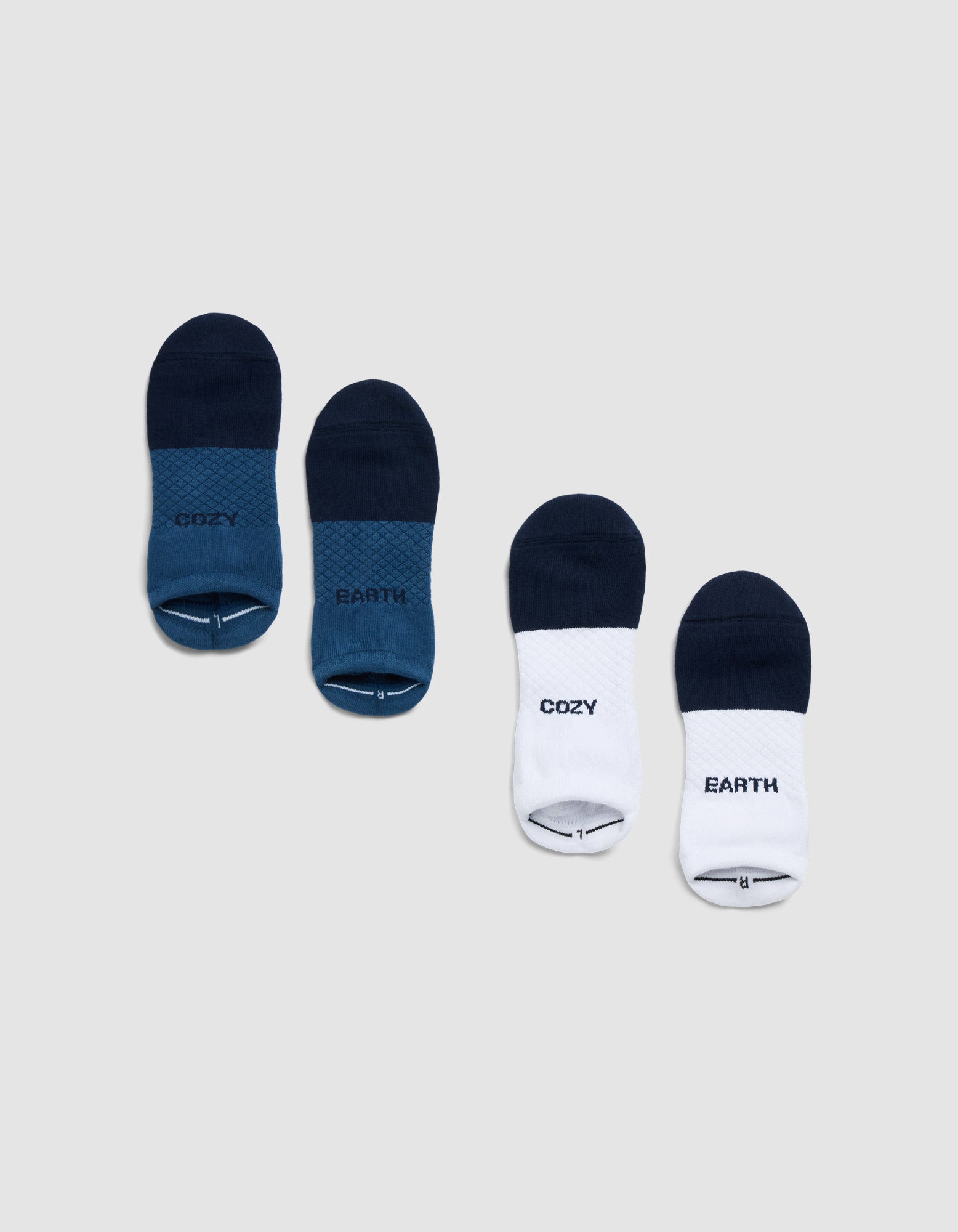 Four pairs of Cozy Earth Essential Ankle Socks are displayed on a gray background: two blue pairs and two white-and-blue pairs, each featuring "COZY" and "EARTH" prints. |Color:Eclipse