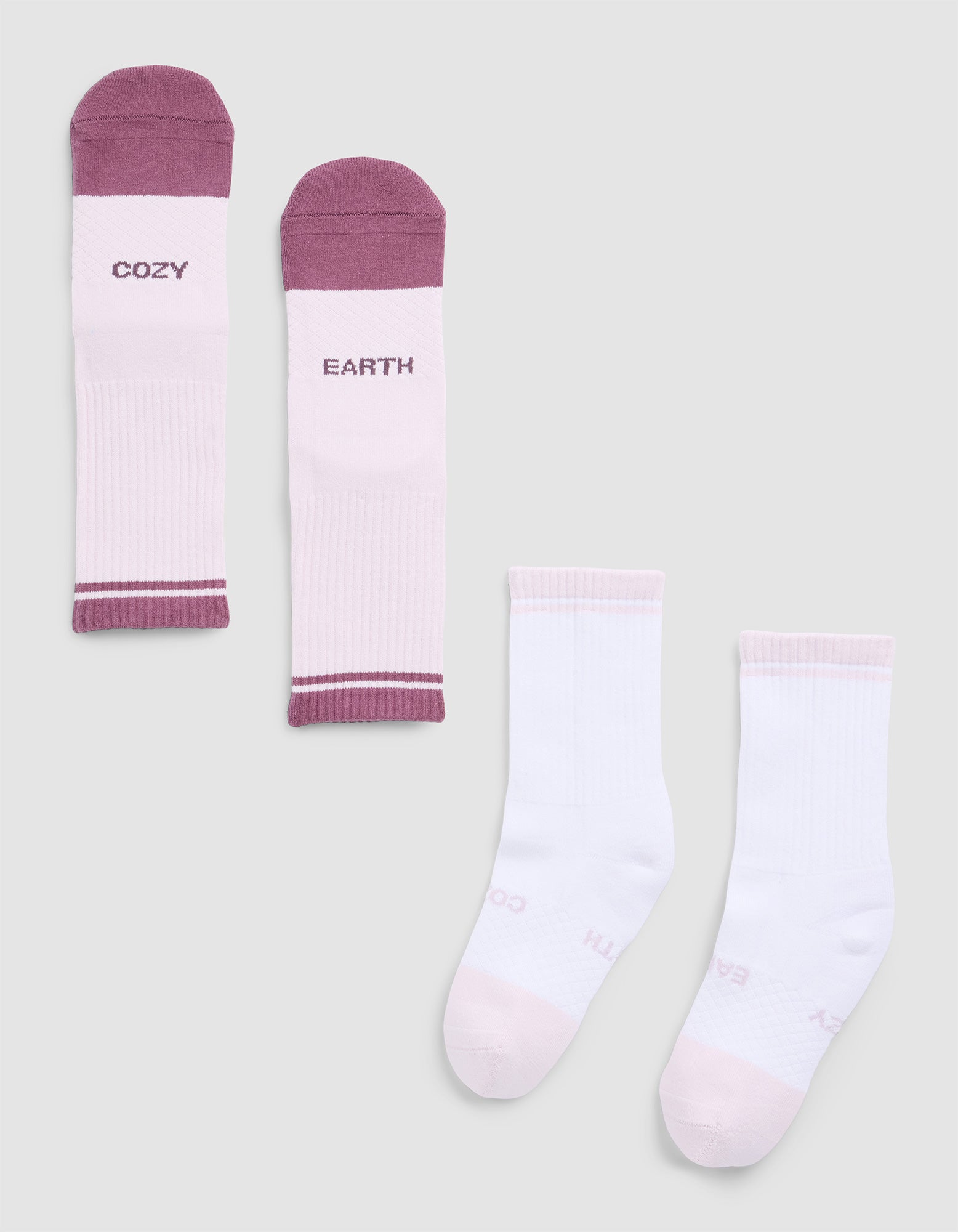 Four Essential Calf Socks by Cozy Earth: The top pair is light pink and maroon with "COZY" and "EARTH" text. The bottom pair is solid light pink and white, both without visible text. 