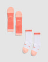 The Essential Calf Sock by Cozy Earth includes two pairs: one mainly coral pink, the other mostly white with coral pink toes, heels, and cuffs. Both have "COZY" and "EARTH" printed on the soles. |Color:Cantaloupe