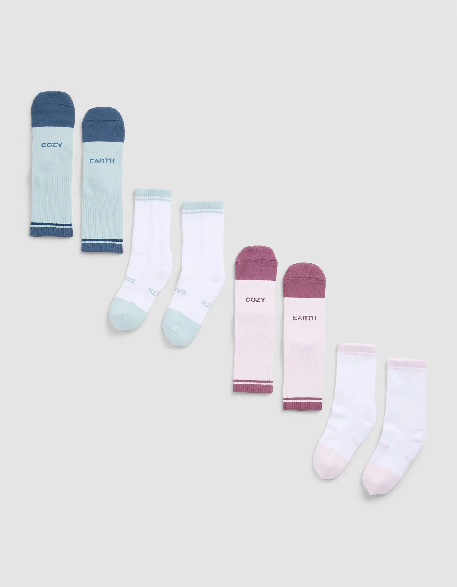 Four pairs of Cozy Earth Essential Calf Socks in blue, mint green, burgundy, and light pink—each featuring text on the tops—are arranged in a row on a light grey background.