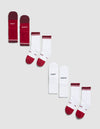 The Cozy Earth Essential Calf Sock 4-Pack includes four pairs: one solid burgundy, two white with red accents, and one white pair featuring "COZY" and "EARTH" text on each sock, displayed diagonally on a light gray background.|Color:Crimson