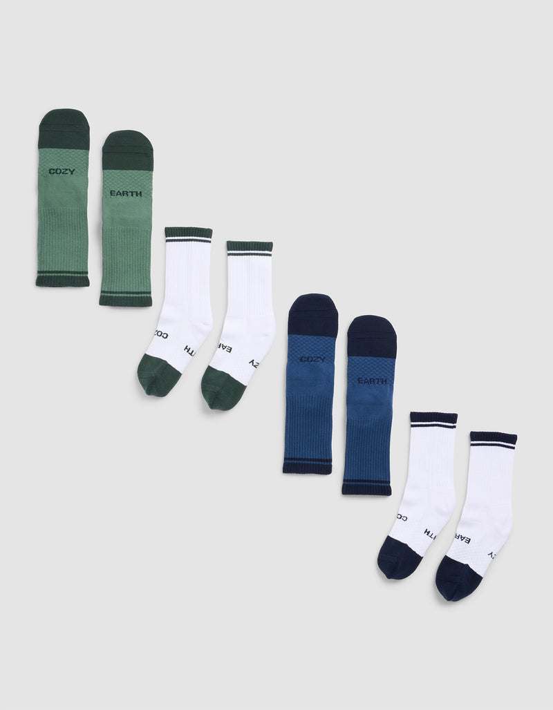 Five pairs of Cozy Earth Essential Calf Socks displayed in a row on a light background, featuring green, white with green accents, blue, blue with navy accents, and white with navy accents.