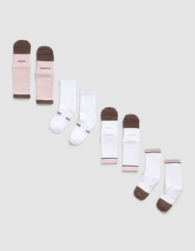The Essential Calf Sock 4-Pack by Cozy Earth features four pairs of socks—two white, one pink and brown with "COZY EARTH" text, and one white with brown toes and heels also featuring the brand’s logo.