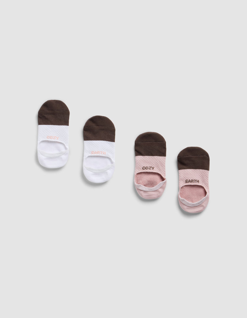 Four pairs of Cozy Earth Essential No-Show Socks are shown on a light gray background—two pairs white with brown toes and heels, two pink with brown toes and heels. "COZY" and "EARTH" are printed on each sock.