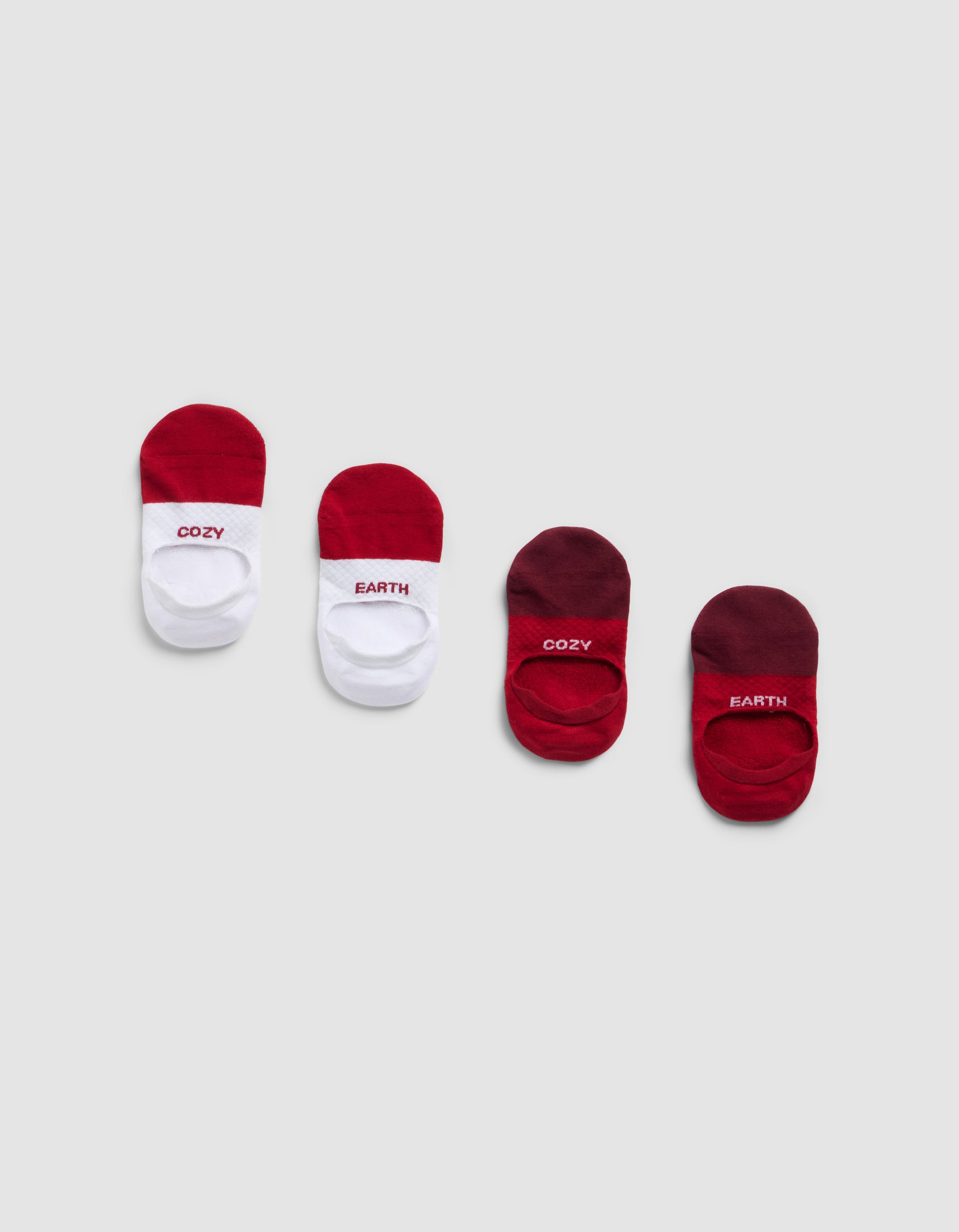 Four pairs of Cozy Earth Essential No-Show Socks in red, white, and burgundy, each with "COZY" or "EARTH" on top, displayed on a light gray background.|Color:Crimson
