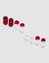 Four pairs of Essential No-Show Socks by Cozy Earth in red, white, and maroon are arranged diagonally on a light gray background, with some socks featuring "COZY" or "EARTH" printed on them.|Color:Crimson