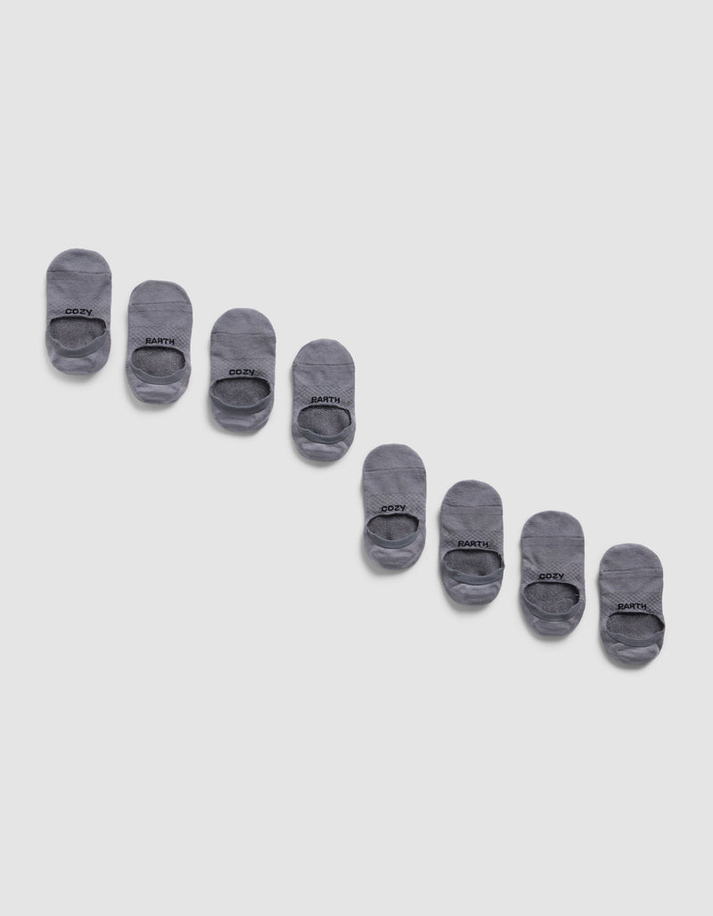 Eight pairs of Cozy Earth Essential No-Show Socks are displayed diagonally on a light gray background, neatly aligned in alternating pairs with black text near the toe.