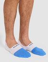 A person wearing Cozy Earth's Essential No-Show Sock in white and blue with visible text near the ankle, standing on a white background. |Color:Harbor