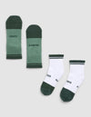 Two pairs of Cozy Earth Essential Quarter Socks are laid flat on a gray background: one pair is green with "COZY" and "EARTH," while the other is white with green toes, heels, and cuffs, featuring the same words. |Color:Spruce