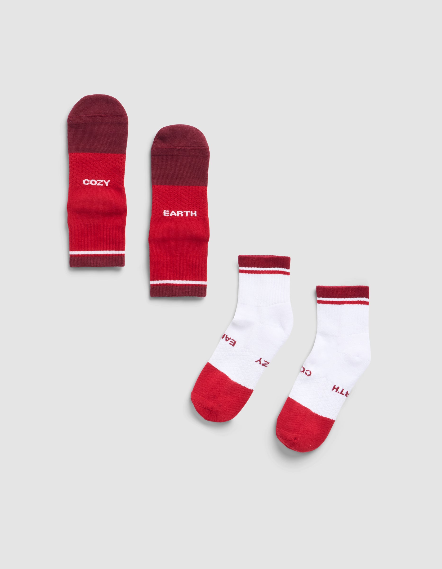 Two pairs of Cozy Earth Essential Quarter Socks: one mostly red with "COZY" and "EARTH" on the soles, the other mostly white with red toes and cuffs, both featuring the same branded soles.|Color:Crimson