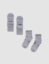 Four Essential Quarter Socks by Cozy Earth in light gray are laid flat on a white background; the top pair displays "COZY" and "EARTH" near the toes, while the bottom pair is oriented with partially visible branding.|Color:Stone