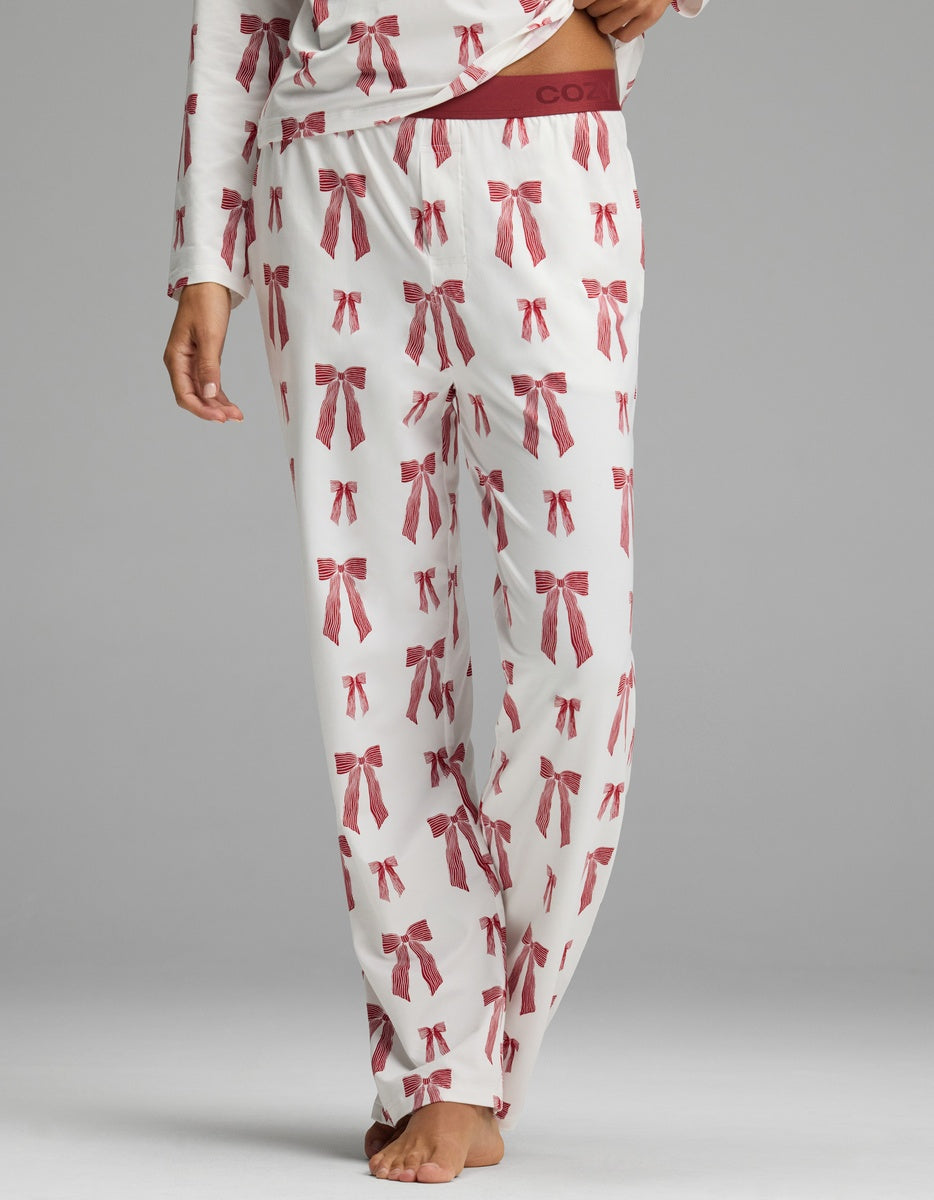 Cozy Earth Women’s First Layer Pajama Pant in white with a pattern of small red ribbon bows and a wide, solid red waistband.