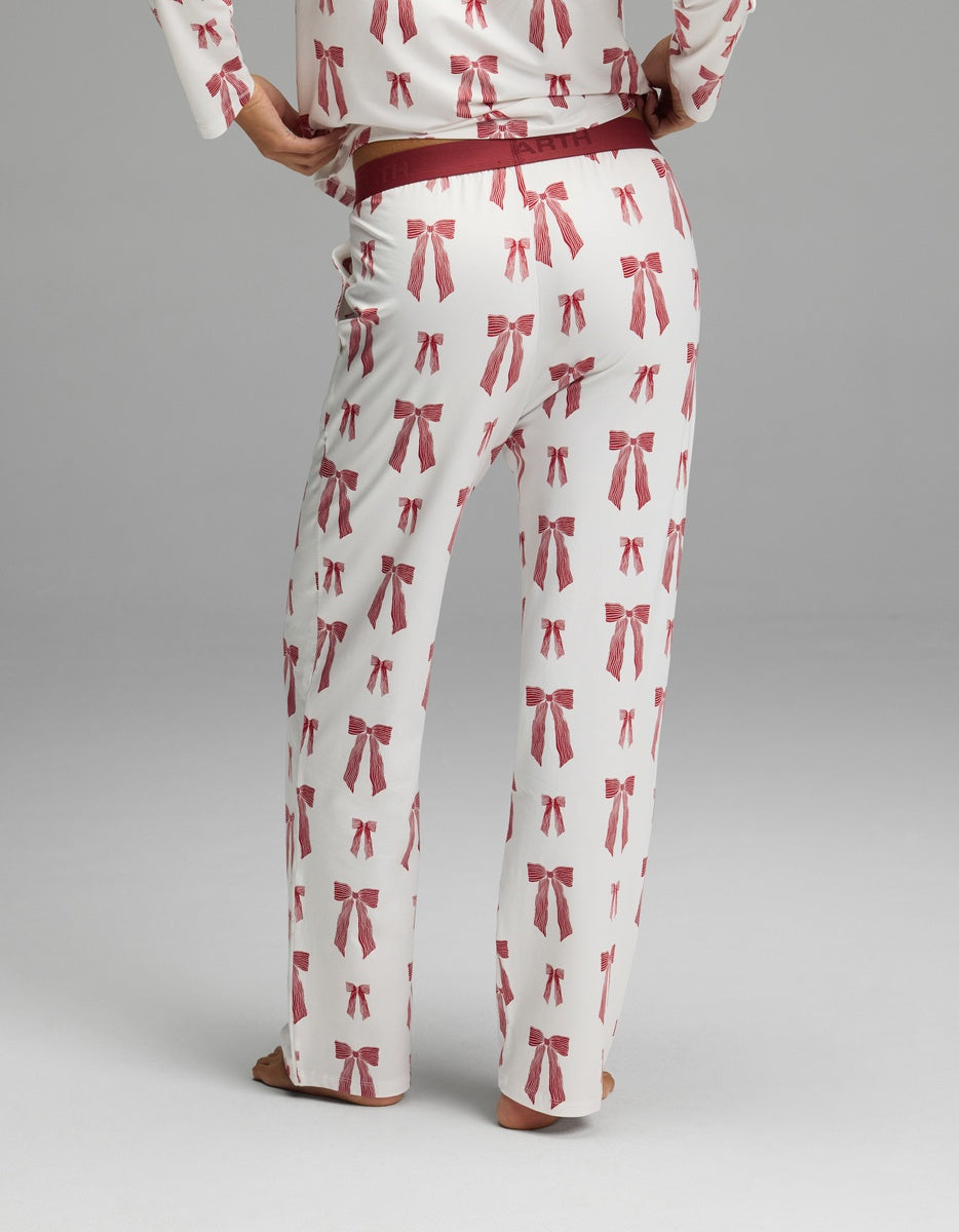Cozy Earth Women’s First Layer Pajama Pant in cream with a red bow print and a maroon elastic waistband.