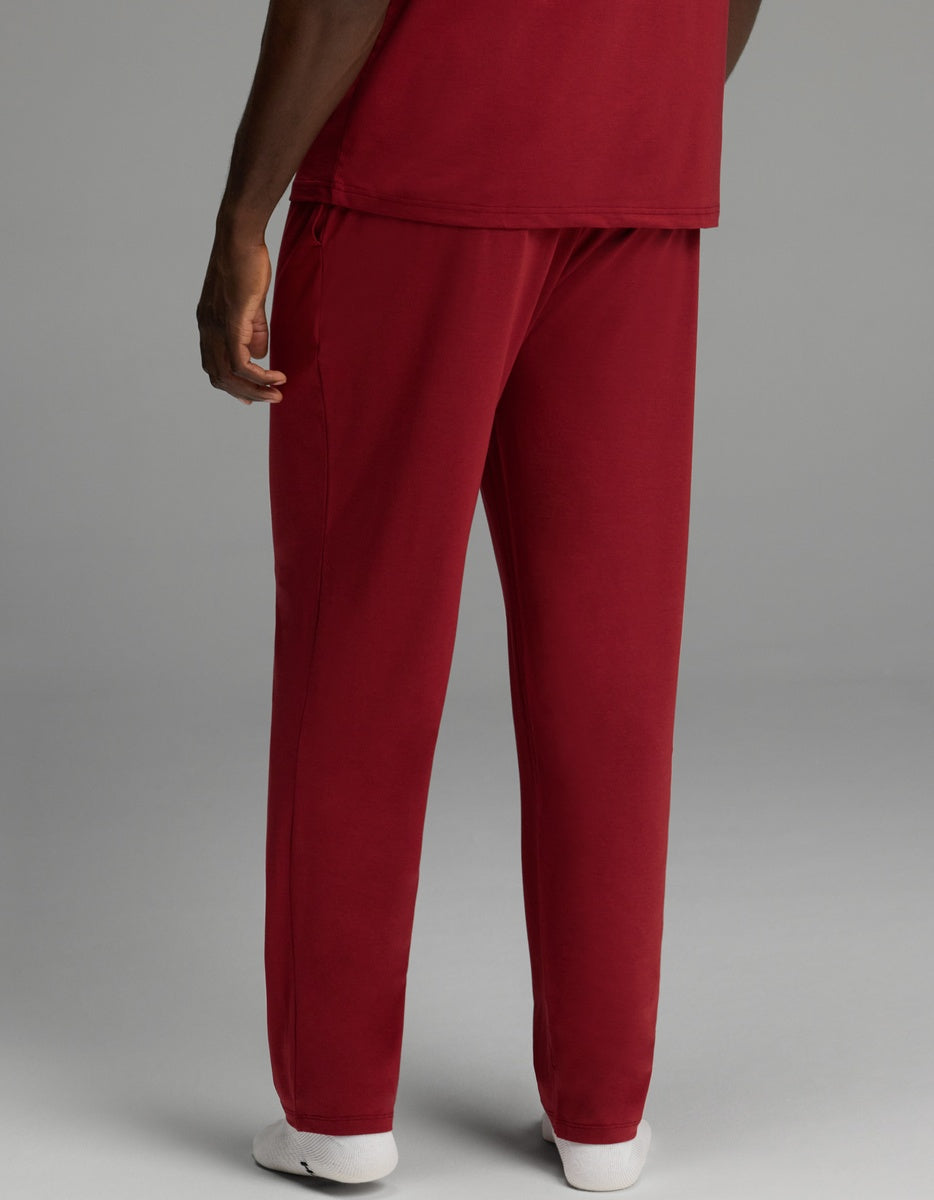 A person viewed from behind, wearing a matching top and maroon Men’s First Layer Pajama Pant.