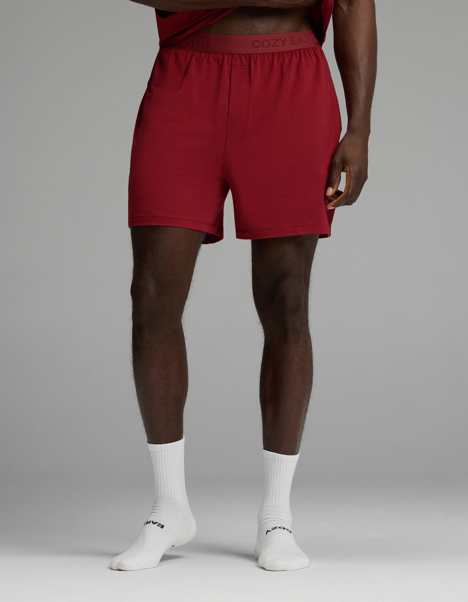 Cozy Earth Men’s First Layer Pajama Short in deep red with a wide elastic waistband, worn with white crew socks.