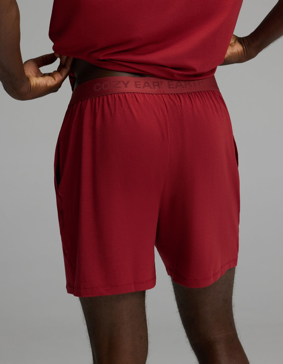 Rear view of a person wearing maroon Cozy Earth Men’s First Layer Pajama Short with a branded elastic waistband.