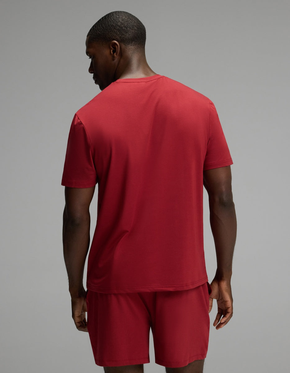 A man seen from behind wearing a red Men’s First Layer Pajama Short Sleeve Tee and matching shorts.