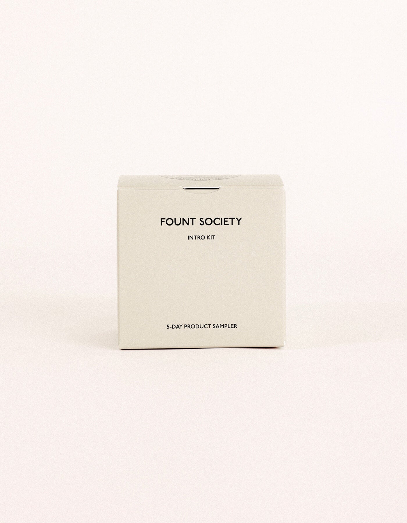 A minimalist beige box labeled "Fount Society Intro Kit" by Cozy Earth rests on a plain light background.