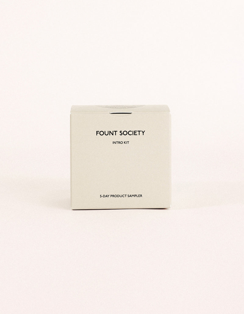A minimalist beige box labeled "Fount Society Intro Kit" by Cozy Earth rests on a plain light background.