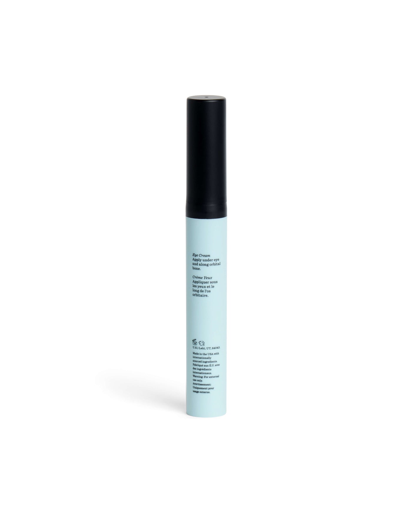 A slim, light blue Eye Cream tube from Cozy Earth with a black cap stands upright on a white background. The front features small, black printed text.