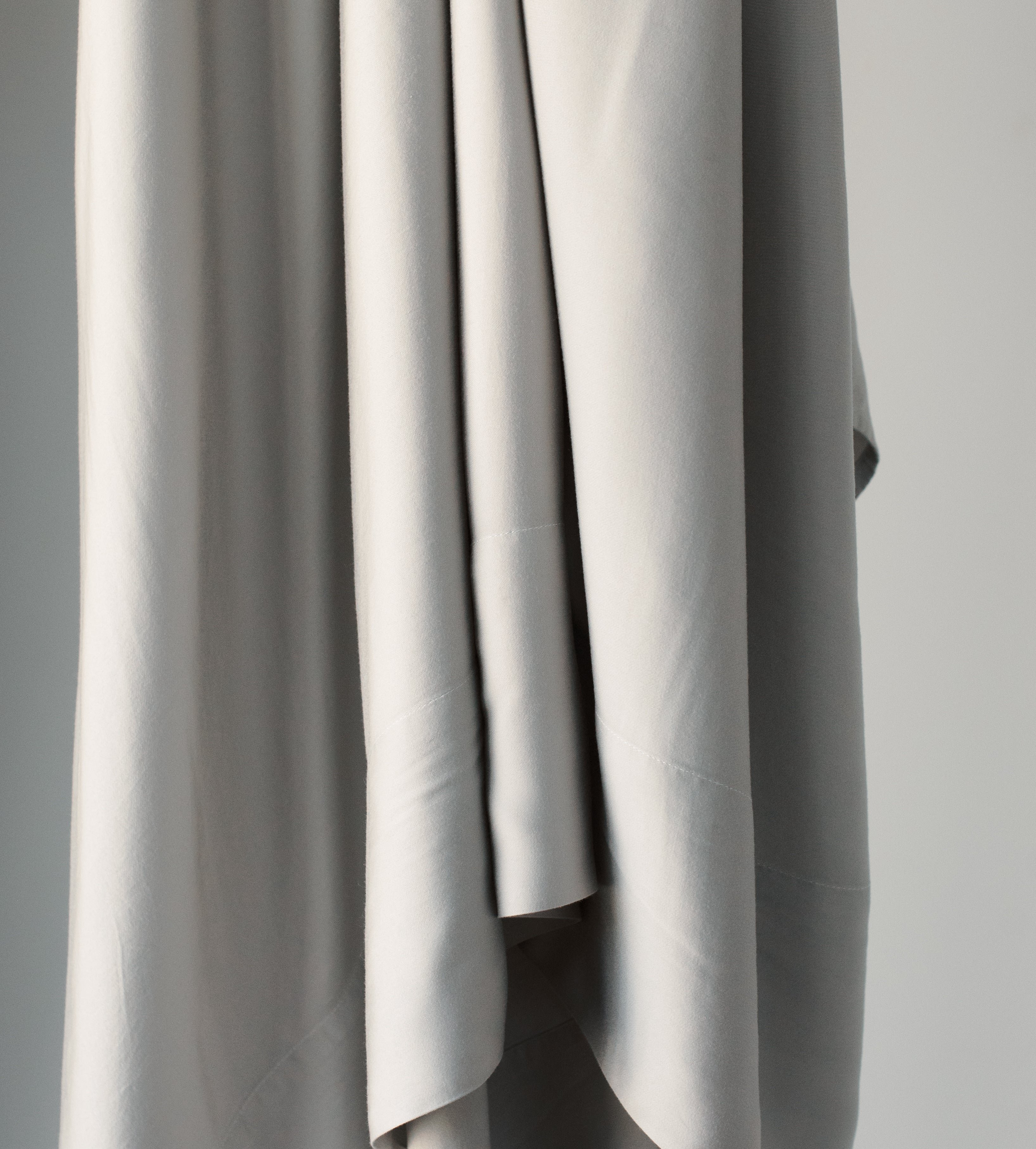 Close up of hanging light grey bedding 