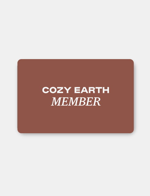 A membership card from Inveterate's Cozy Earth Membership line, displaying a brown background with "COZY EARTH MEMBER" written in white capital letters.