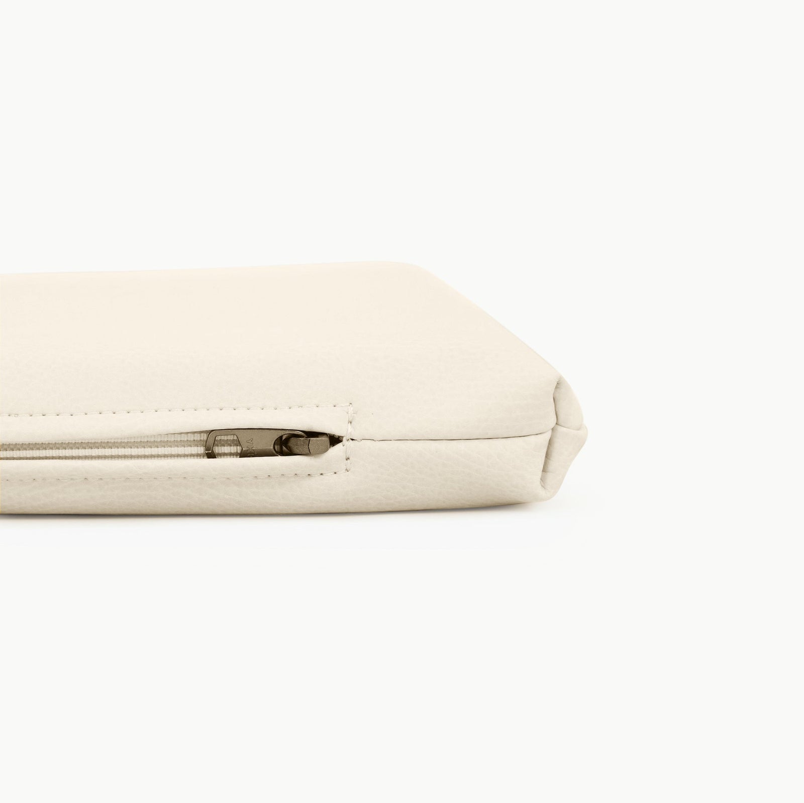 A close-up of the Gathre Wholesale Padded Changing Mat shows its cream color, textured surface, and zippered corner detail against a plain white background.