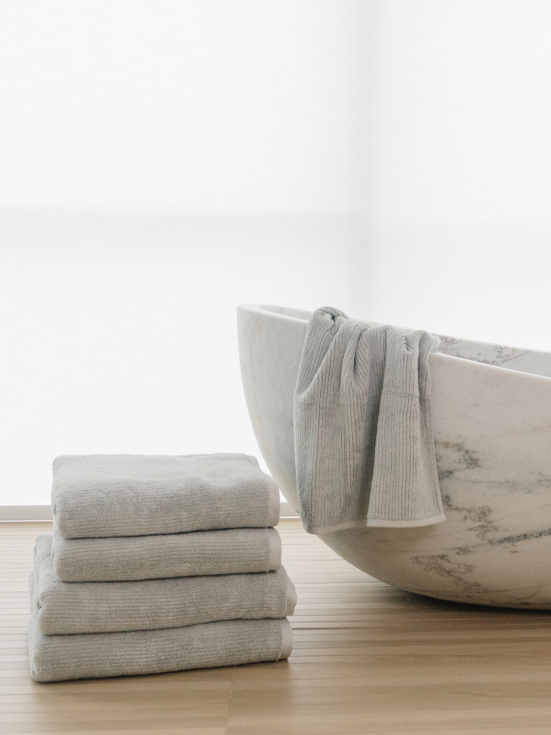 Complete Ribbed Terry Bath Bundle in the color Light Grey. Photo of Complete Ribbed Terry Bath Bundle taken in a bathroom next to a bathtub. |Color: Light Grey