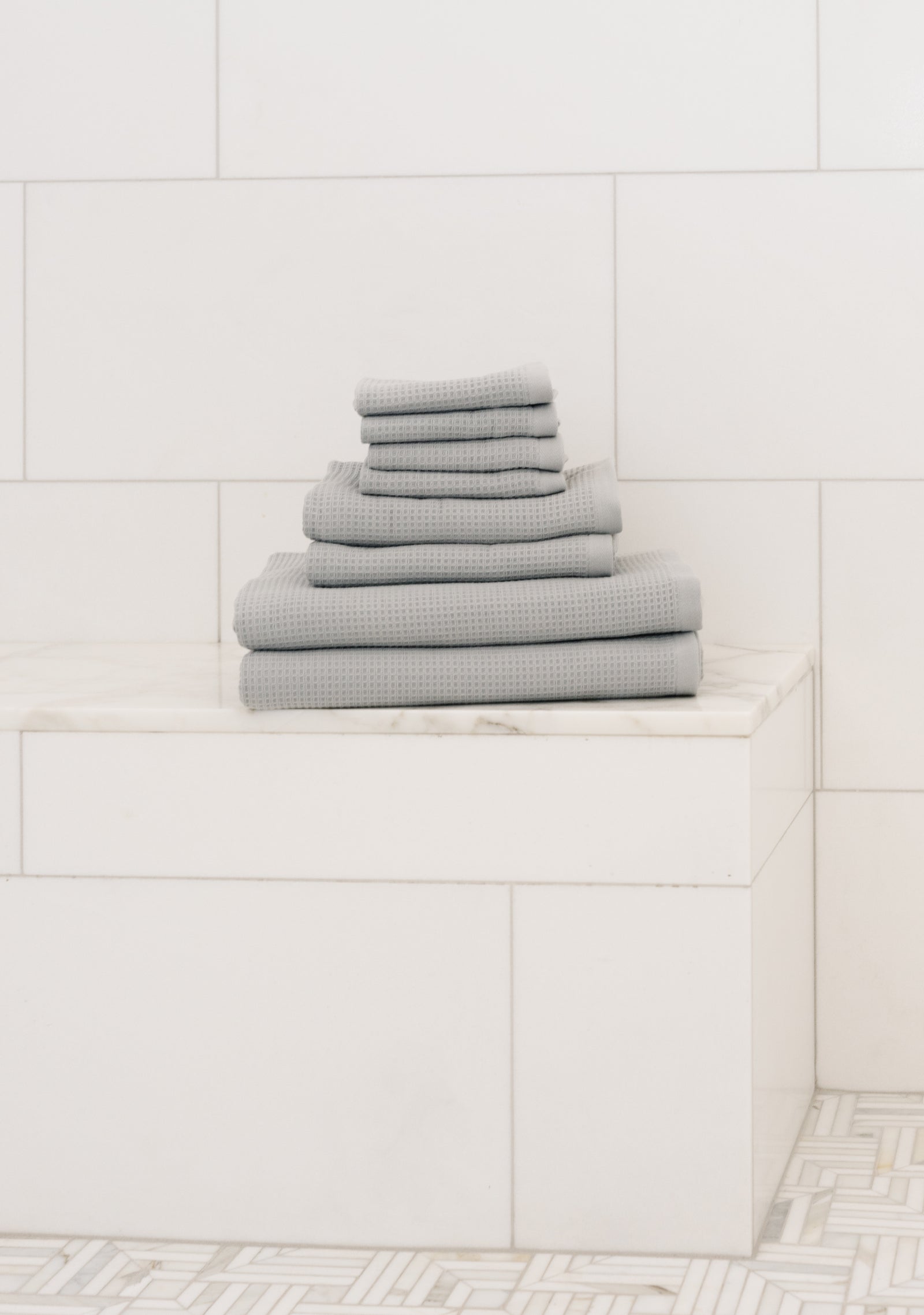 Waffle Bath Towel Set in the color Harbor Mist. Photo of Harbor Mist Waffle Bath Towel Set taken resting on a marble counter top. 