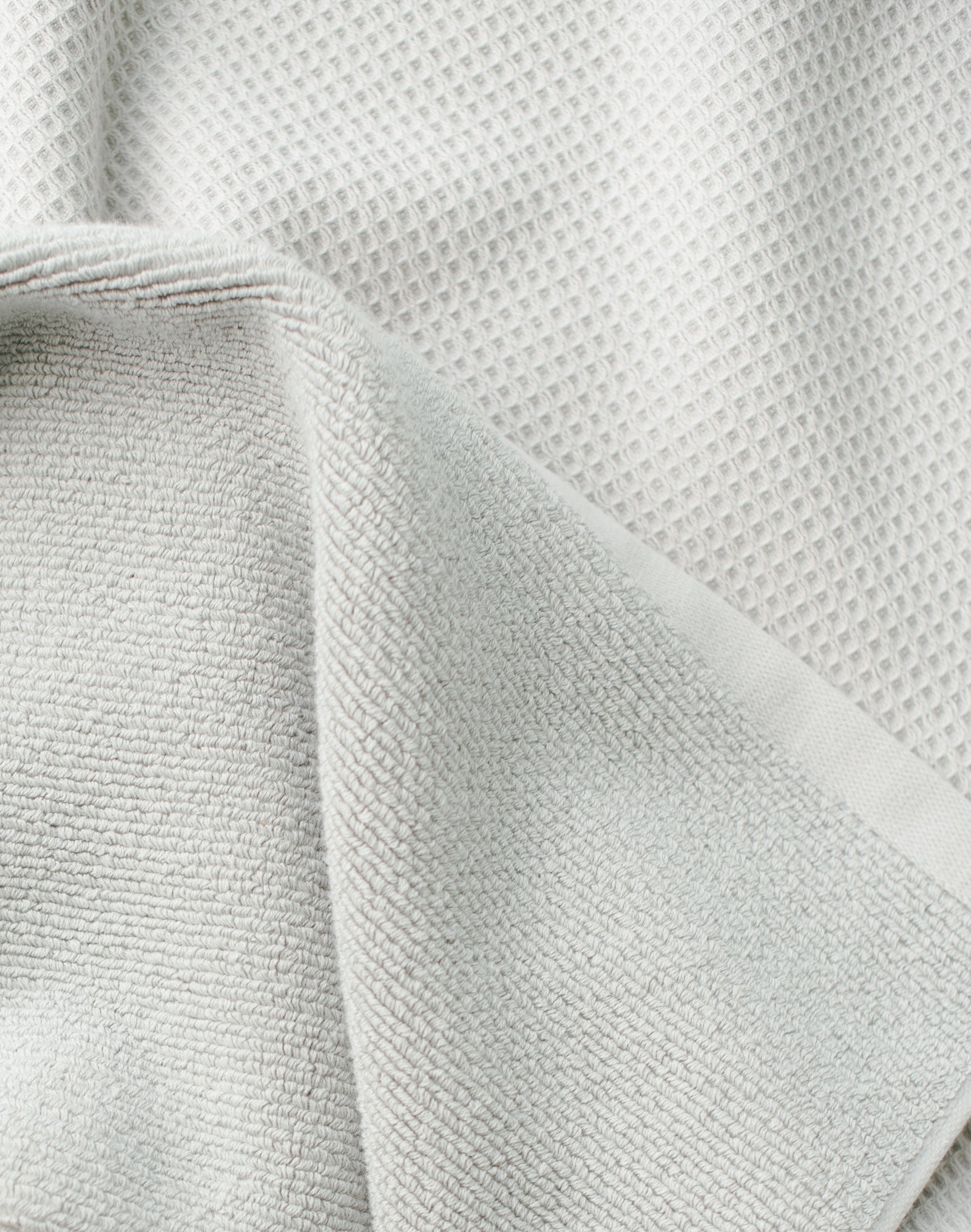 Waffle Bath Towel in the color Light Grey. Photo of Light Grey Waffle Bath Towel taken close up only showing the towel 
