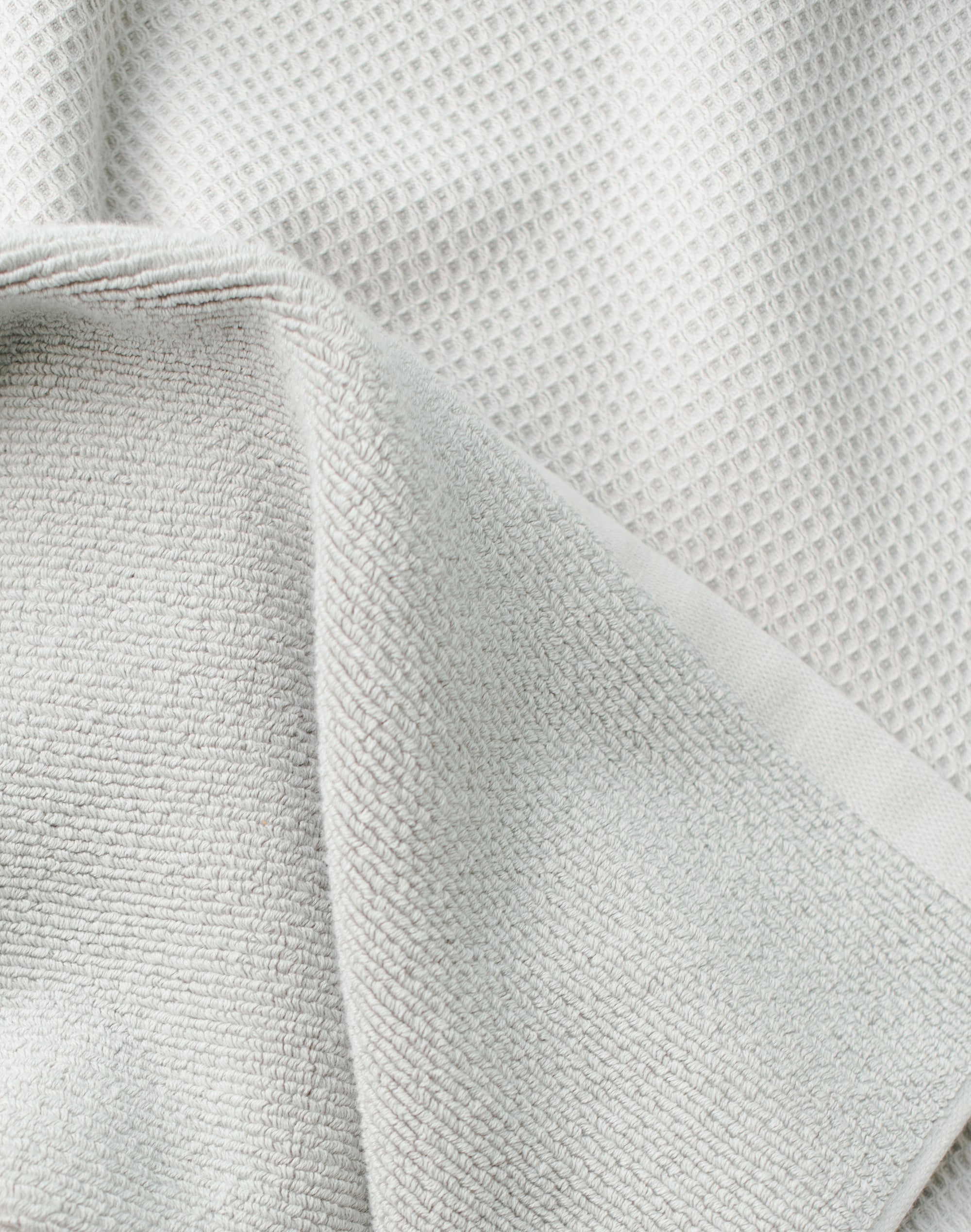 Waffle Bath Towel in the color Light Grey. Photo of Light Grey Waffle Bath Towel taken close up only showing the towel |Color: Light Grey