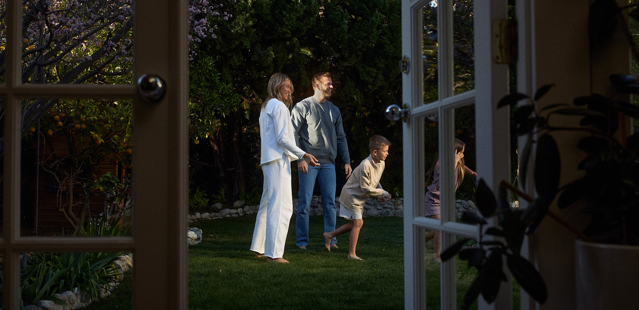 Family playing in a garden at night