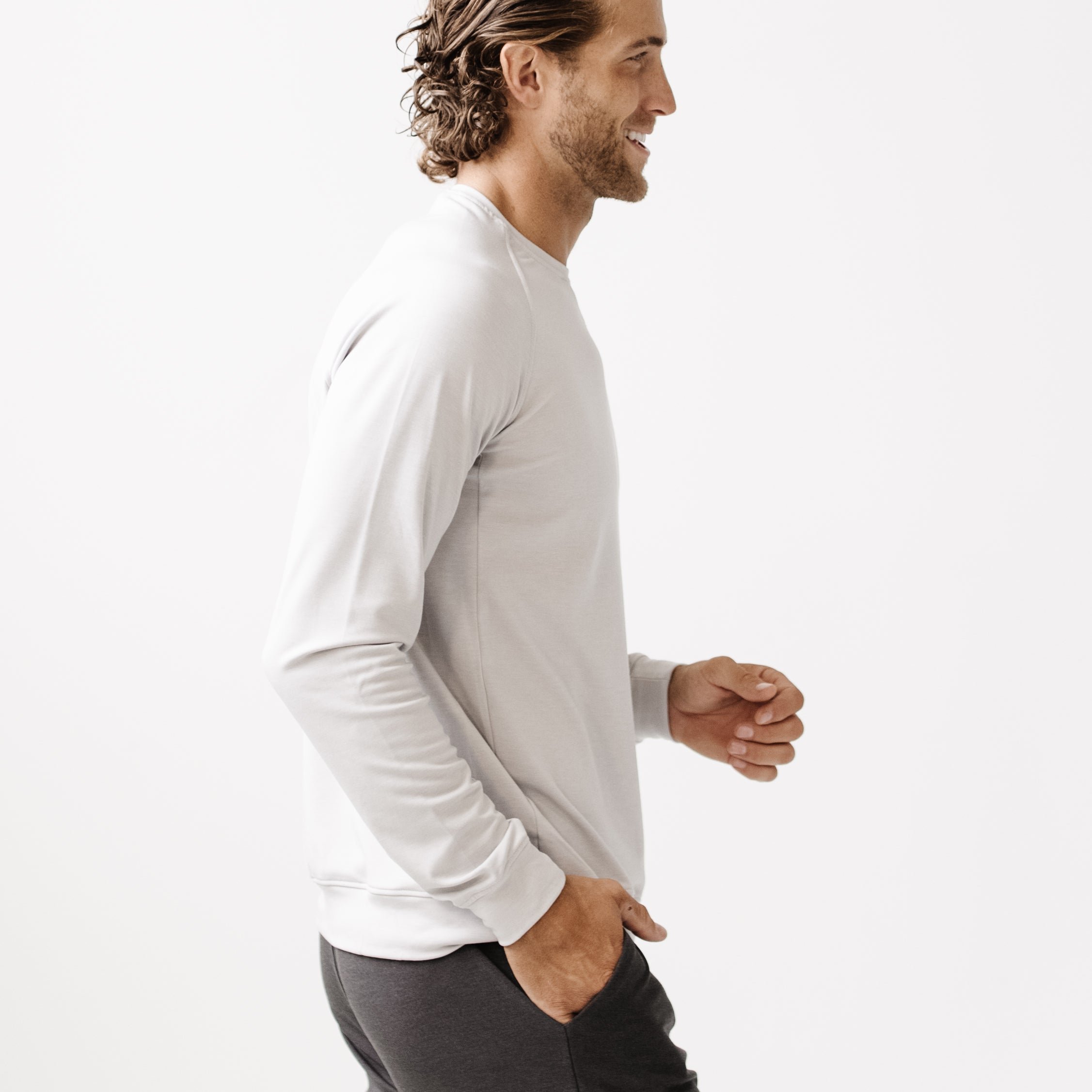 Light Grey/Charcoal Men's Bamboo Jogger Set. There is a man wearing the jogger set. He is standing in a well lit room in a home.