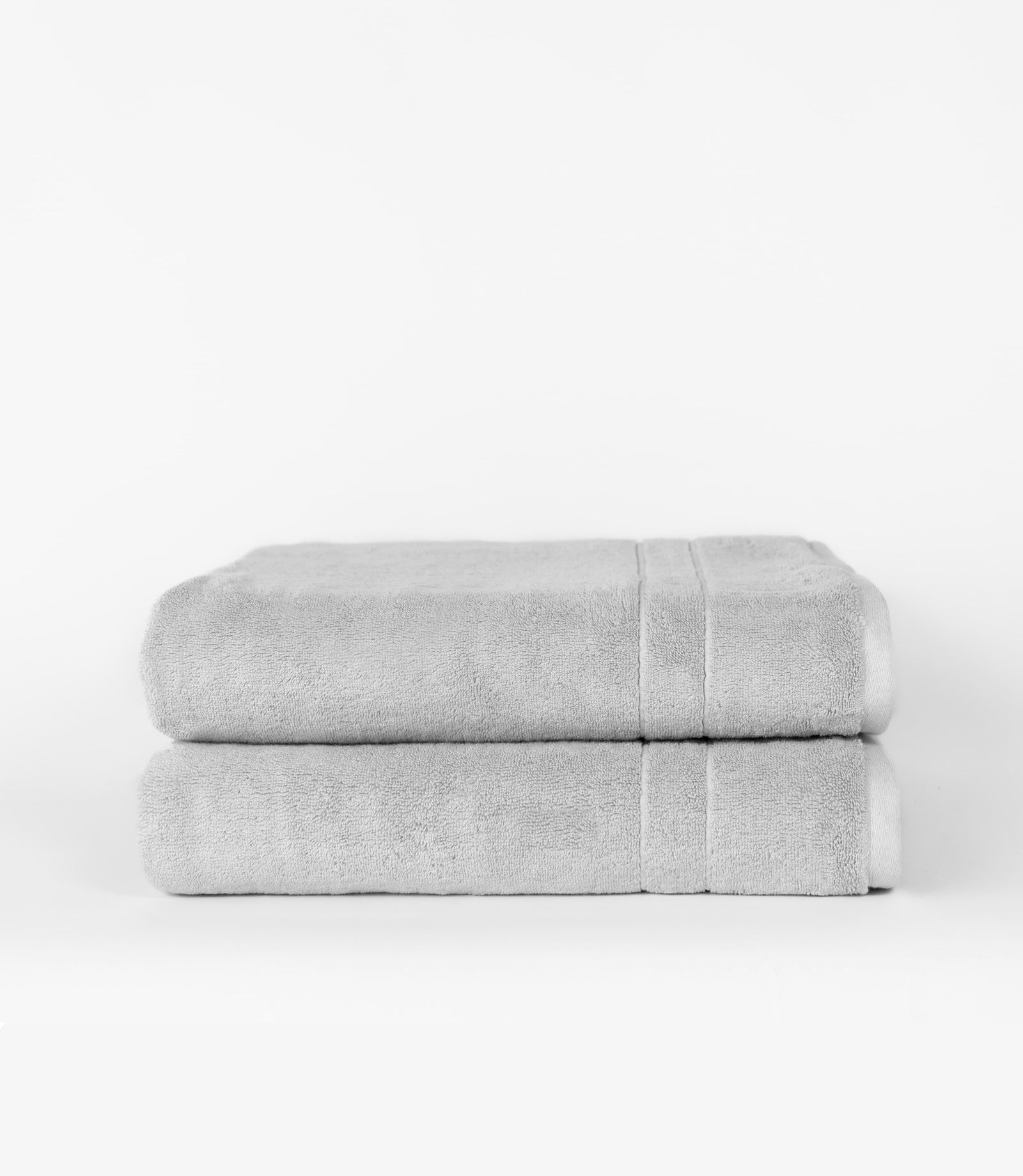 Premium Plush Bath Sheets in the color light grey. Photo of bath sheets taken with white background 