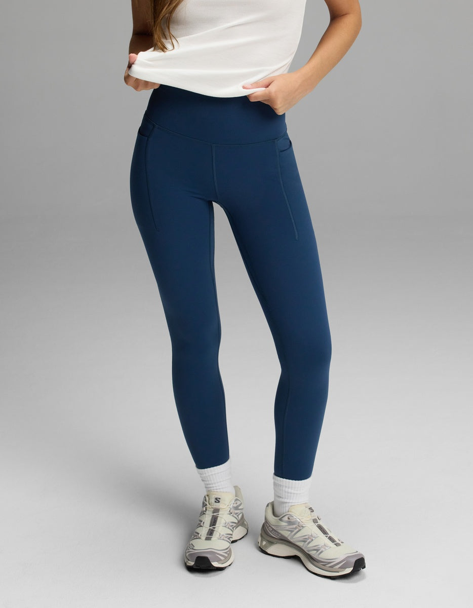 Cozy Earth Women’s Liv Leggings with Pockets in navy blue, styled with white socks and neutral sneakers.|Color:Obsidian