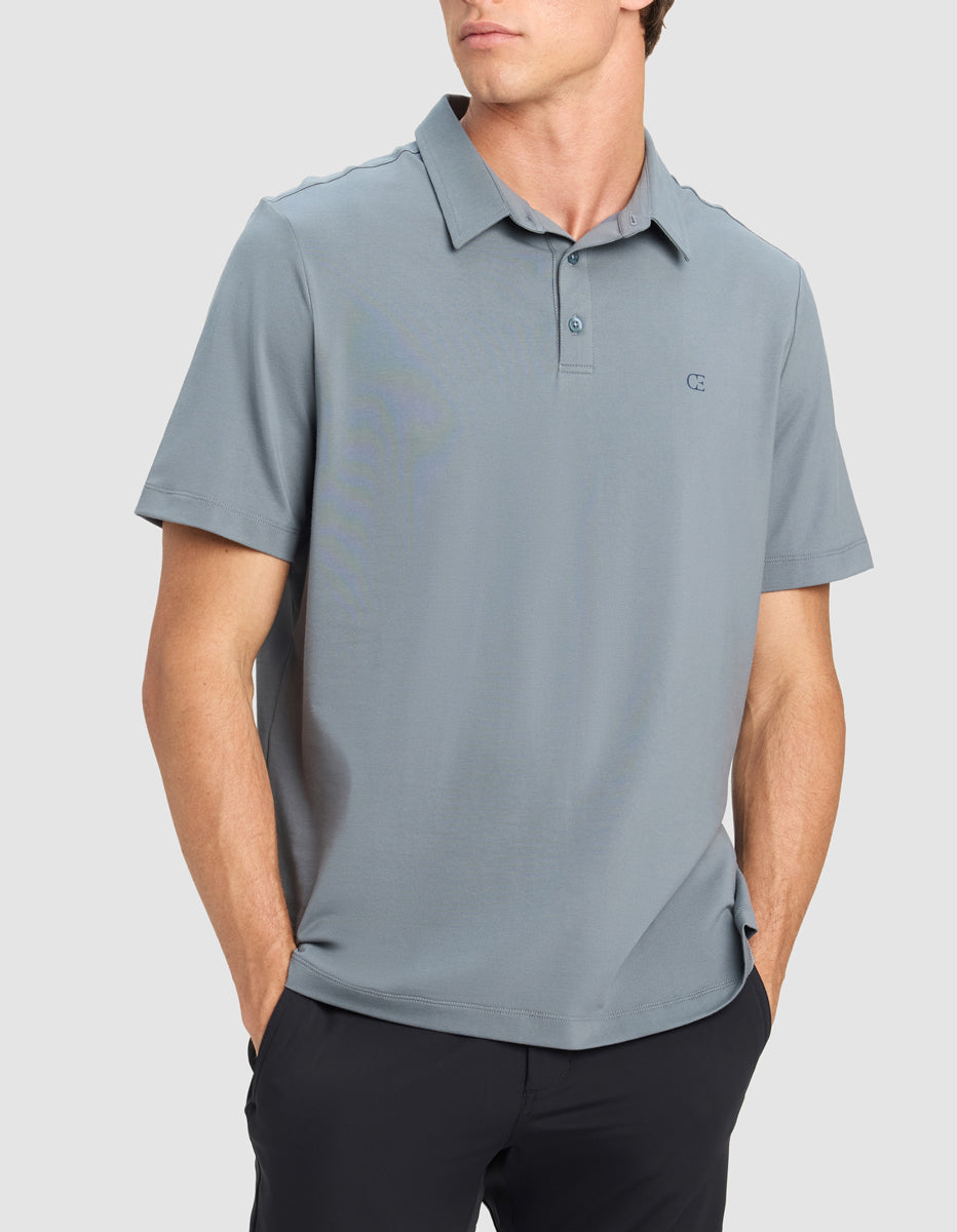 Man wearing a blue Cozy Earth Everyday Polo shirt with a brand logo on a light gray background