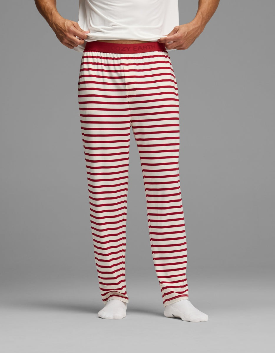 Man wearing Cozy Earth Men’s First Layer Pajama Pant featuring white fabric with red horizontal stripes and a wide elastic waistband.