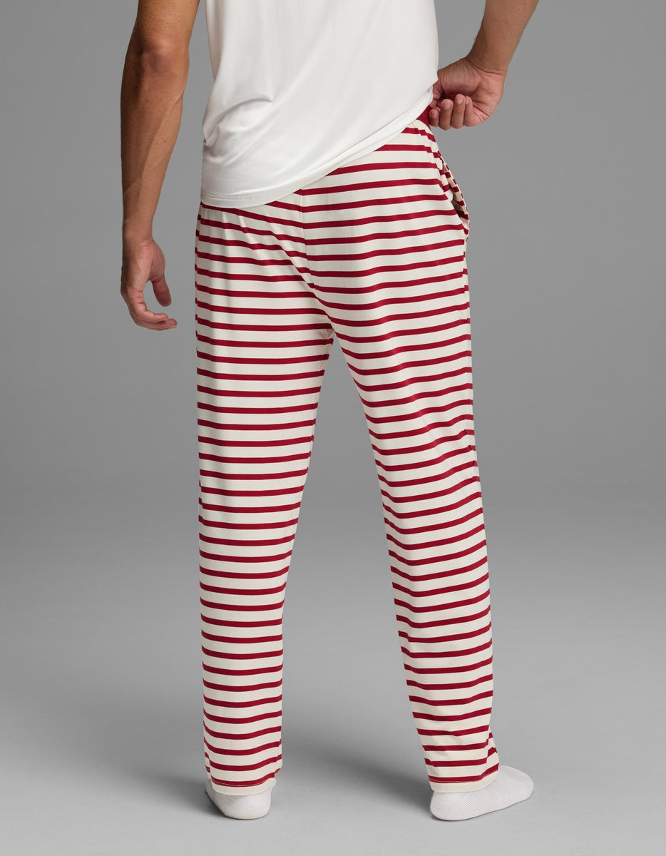 Back view of a person wearing red and white horizontally striped Cozy Earth Men’s First Layer Pajama Pant.