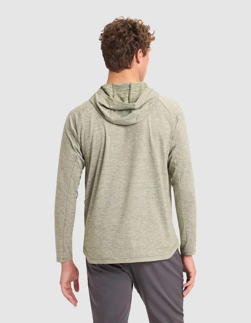 A man with curly hair is seen from behind wearing the Cozy Earth Men's Lightweight Performance Hoodie in light green and gray pants, standing against a plain white background.