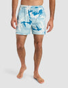 A barefoot man models Cozy Earth’s Men’s Day & Night Short 5" in a light blue, white, and dark blue camo print with an elastic waistband. His upper body is out of frame against a plain white background.|Color:Tide Camo