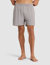 A person stands barefoot wearing the Cozy Earth Men's Performance Sleep Short in light gray, featuring an elastic waistband. The image is cropped from the waist down against a plain white background. |Color:Stone