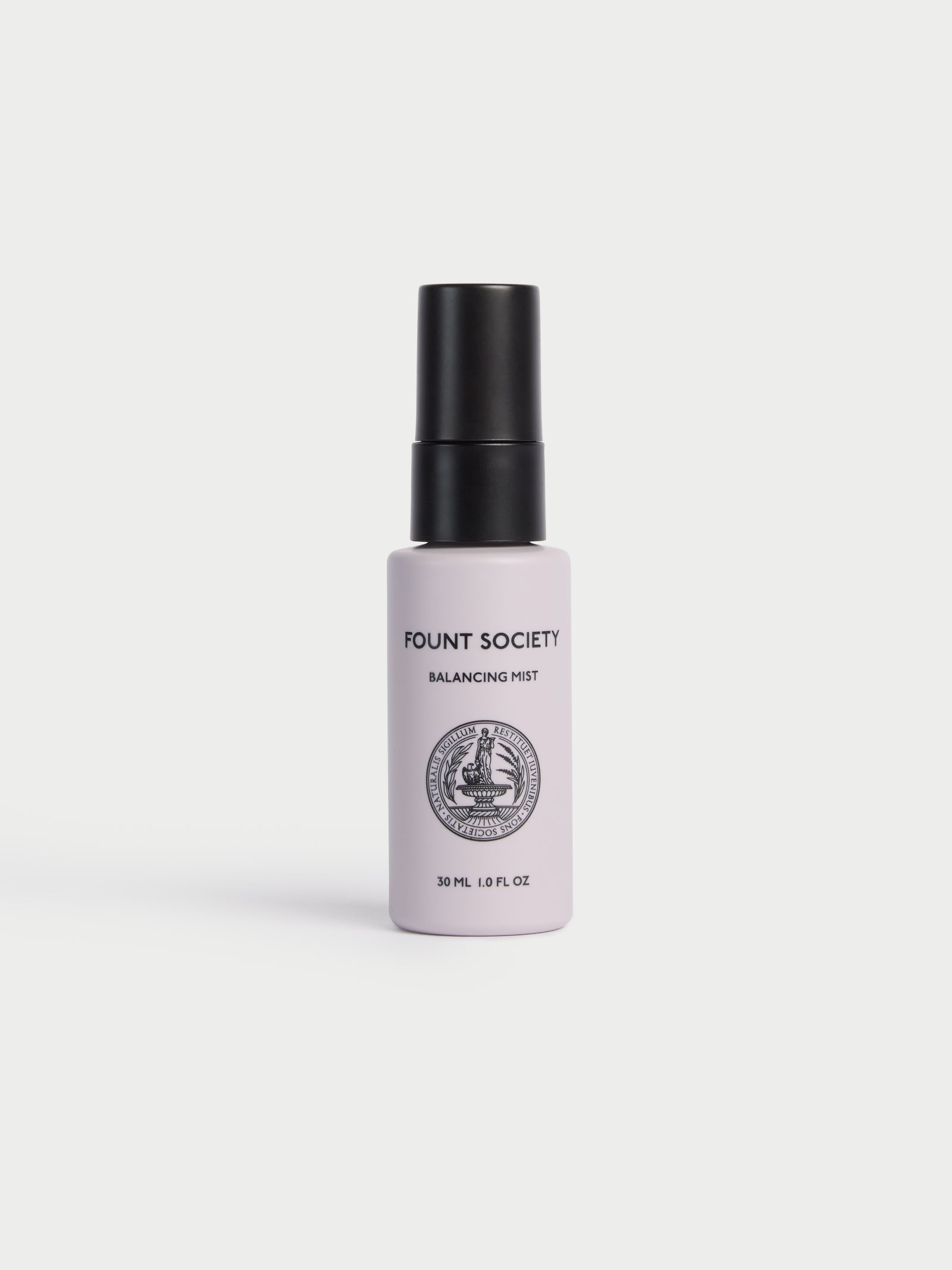A small, white spray bottle labeled "Cozy Earth Balancing Face Mist" with a black cap and circular logo stands upright on a white background. 