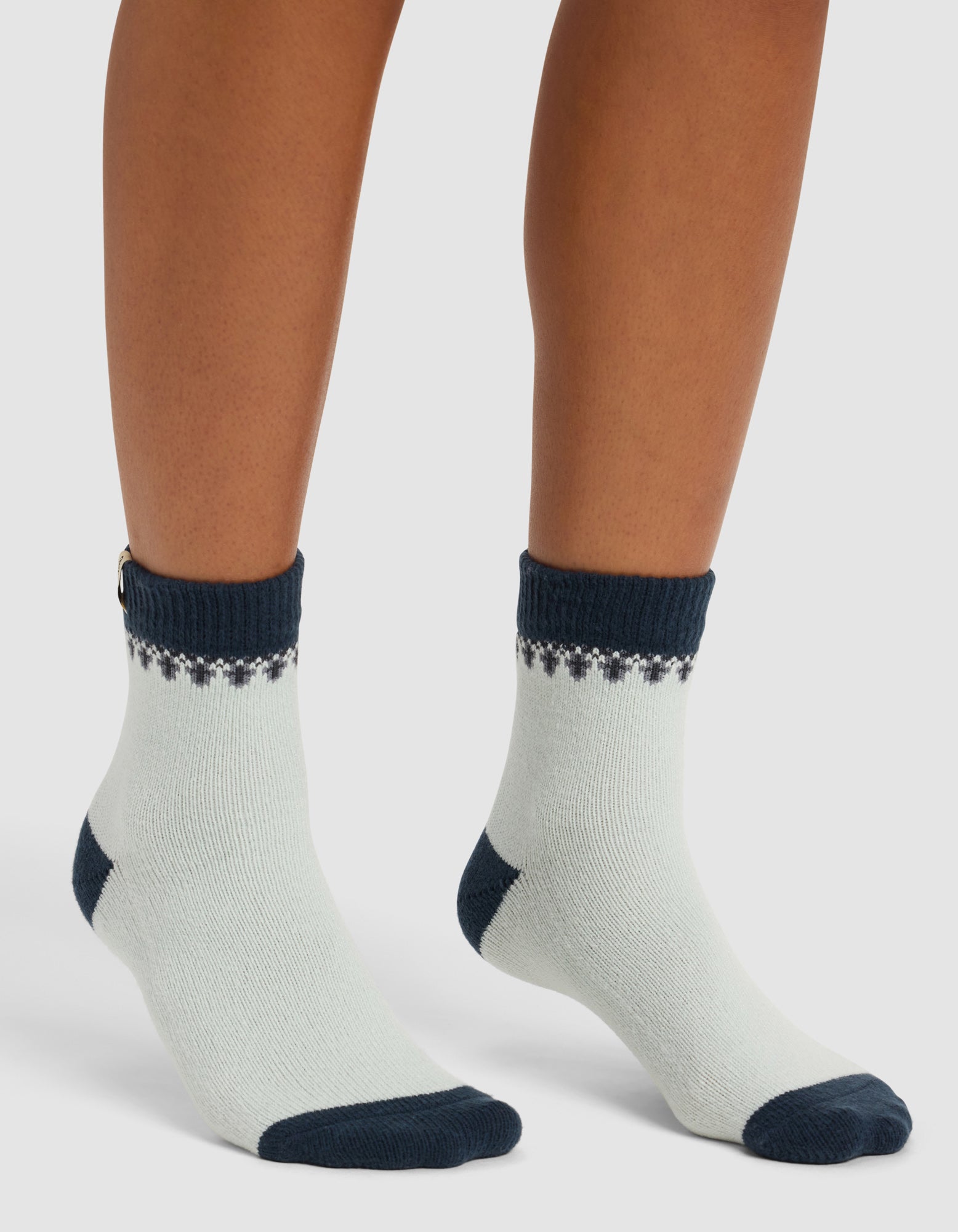A person wearing Cozy Earth's The Mistletoe Plush Modern Crew Sock stands on a white background.|Color:Mist