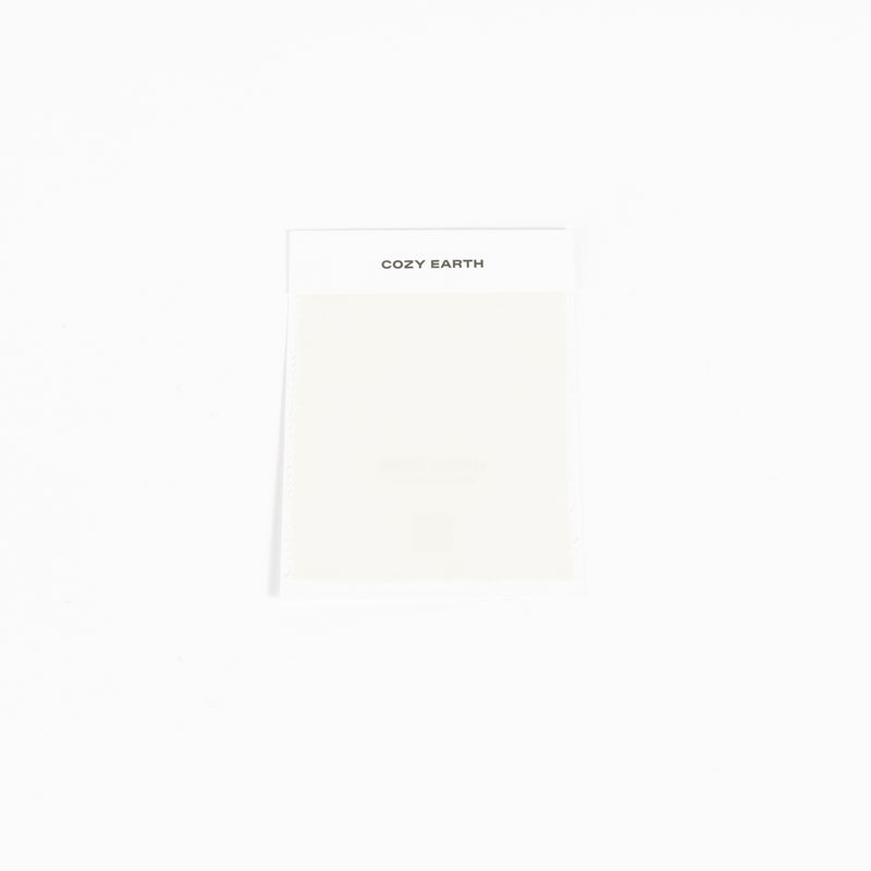 A compact rectangular package set against a white background features the "Cozy Earth" label at the top and appears to contain a light-colored item, specifically a Bamboo Sheet Swatch.