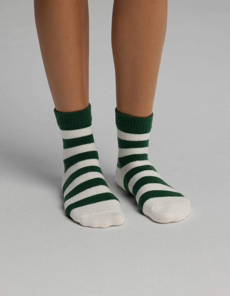 A pair of Cozy Earth Women’s Plush Lounge Quarter Socks featuring dark green and white horizontal stripes.